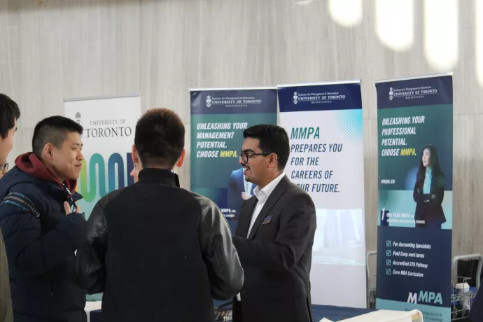 Amit at the 2023 IMI Grad Day talking to prospective students